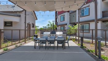 a patio with a dining table and chairs under a canopyat Weylyn Luxury Apartments, Laveen, AZ